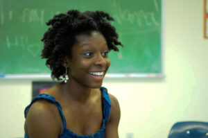 Alanna is a Black woman with a playful and sincere expression.