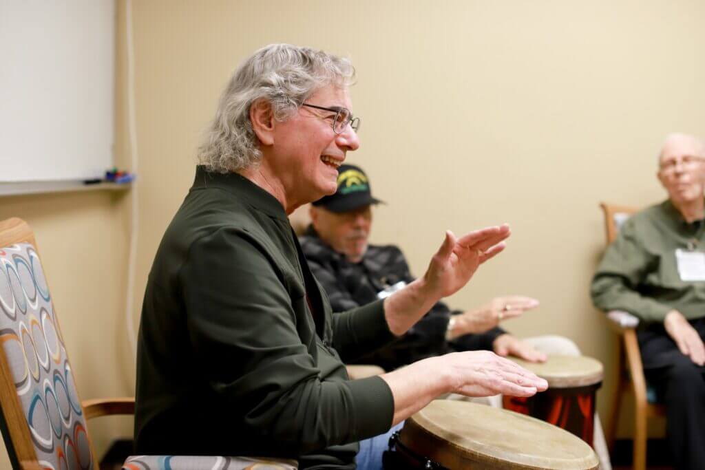 Man playing on a hand held drum