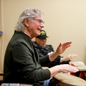Man playing on a hand held drum