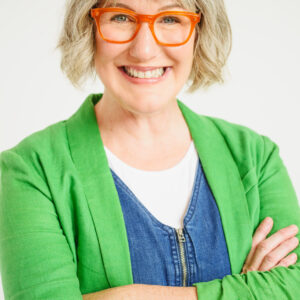 Headshot of woman with bob cut hairsyle wearing green blazer.