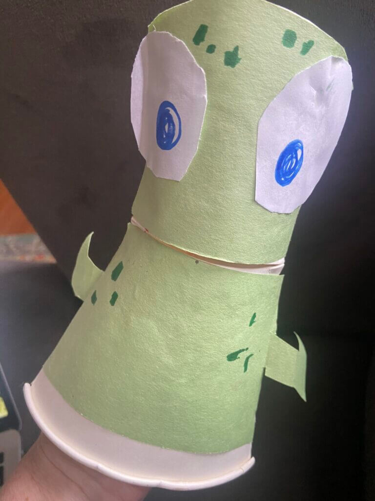 A cup based puppet that looks like an alien.
