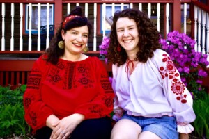 Nanilo are two white females wearing red and white shirts.