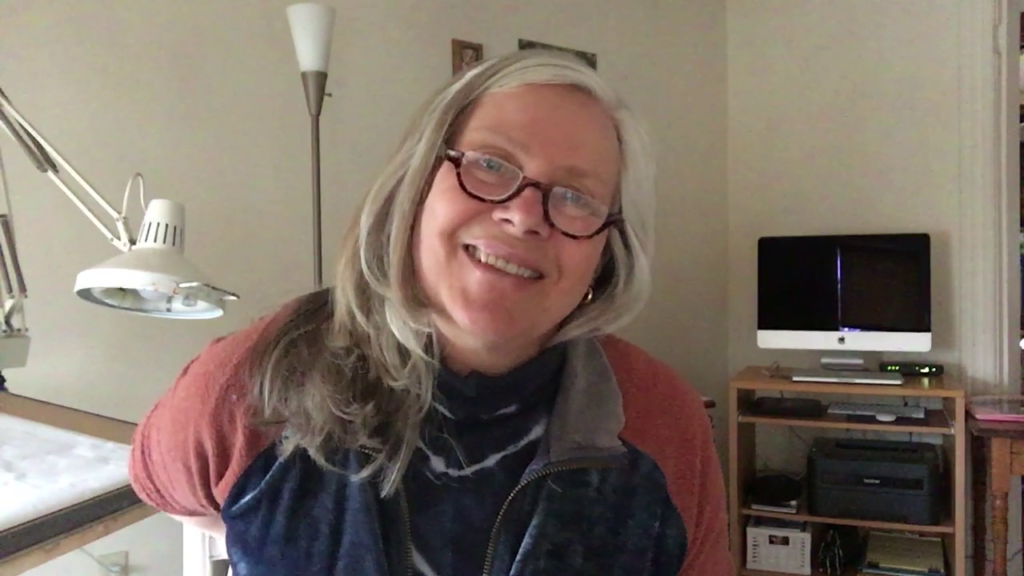Marie sits in her home studio.