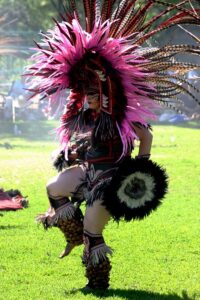 A traditional dancer in beautiful feathered costume.