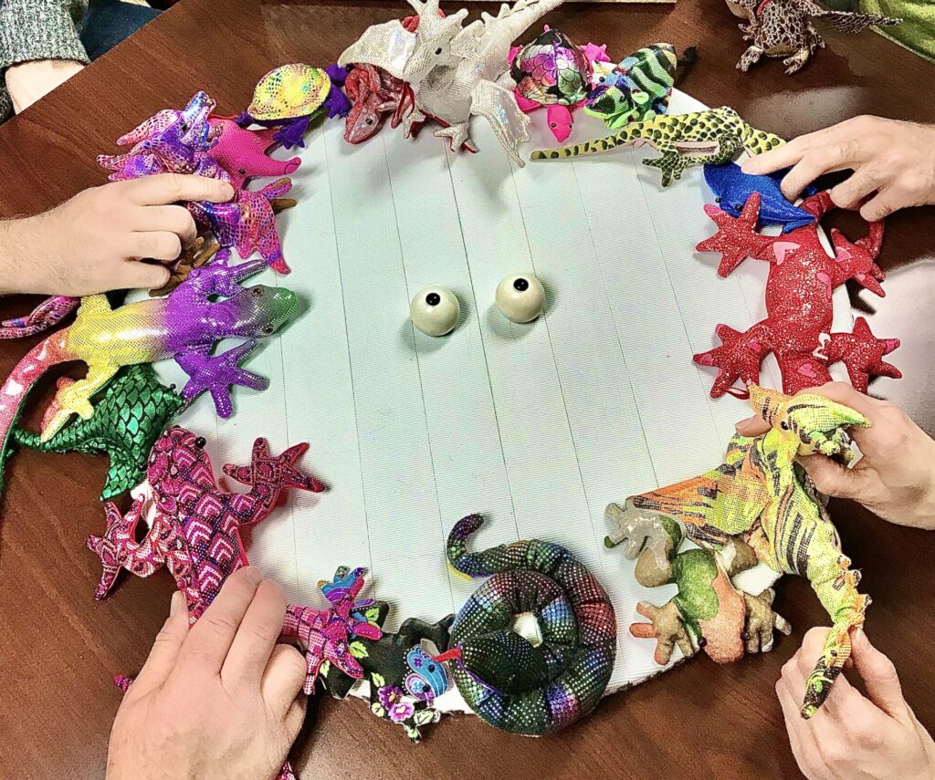 A dish with hands touching stuffed animals on the edges.