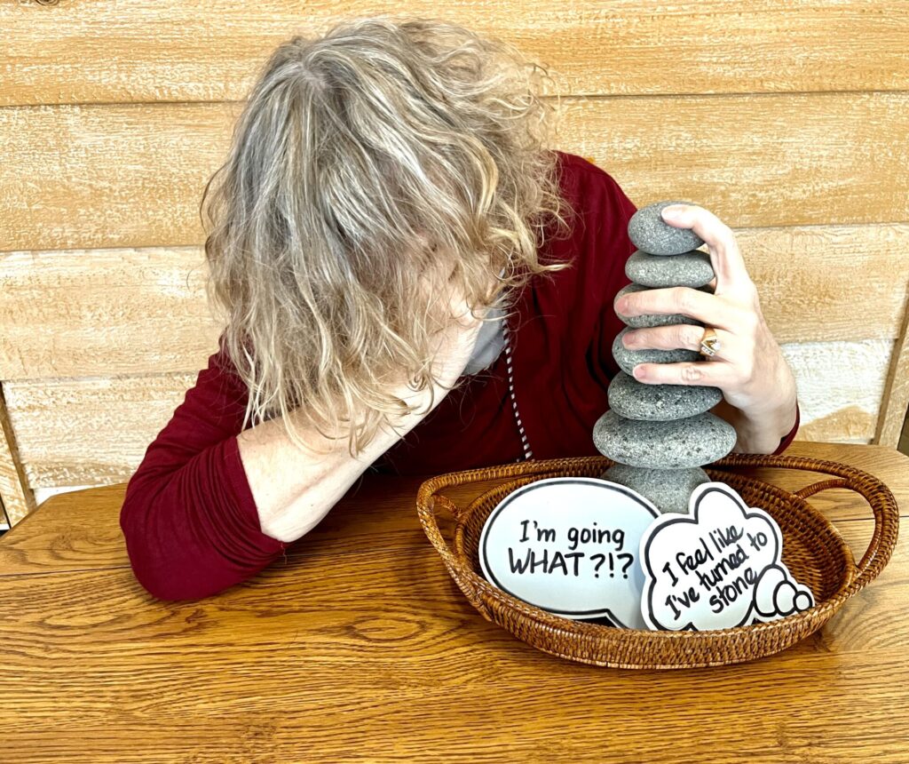 Picture of Linda with her head in her hand.