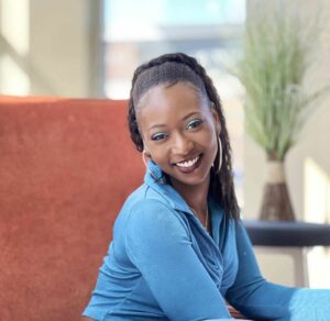 Dralandra Larkins wearing a blue shirt and smiling.