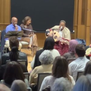 Aarda performing in front of a group.