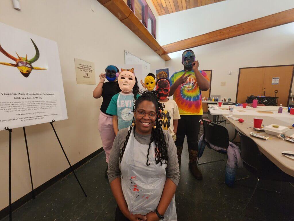 Karen Caldwell with youth wearing created masks. 