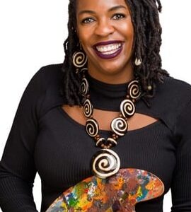Karen Caldwell smiling and holding a painting tool.