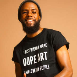 Joe Daivs in a shirt that says, "I just want to make dope art and love my people."
