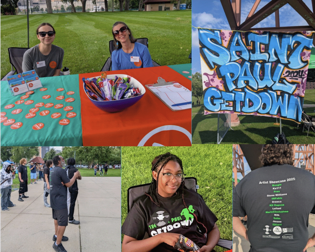 Photos from the Saint Paul GetDown 2025 event: two smiling volunteers sit behind a table with buttons, flyers, candy, and a clipboard; a colorful graffiti-style banner reads 'Saint Paul GetDown'; people gather and chat outdoors in a park; a young woman in a GetDown T-shirt smiles while seated; and the back of a T-shirt lists artists in the 2025 showcase.