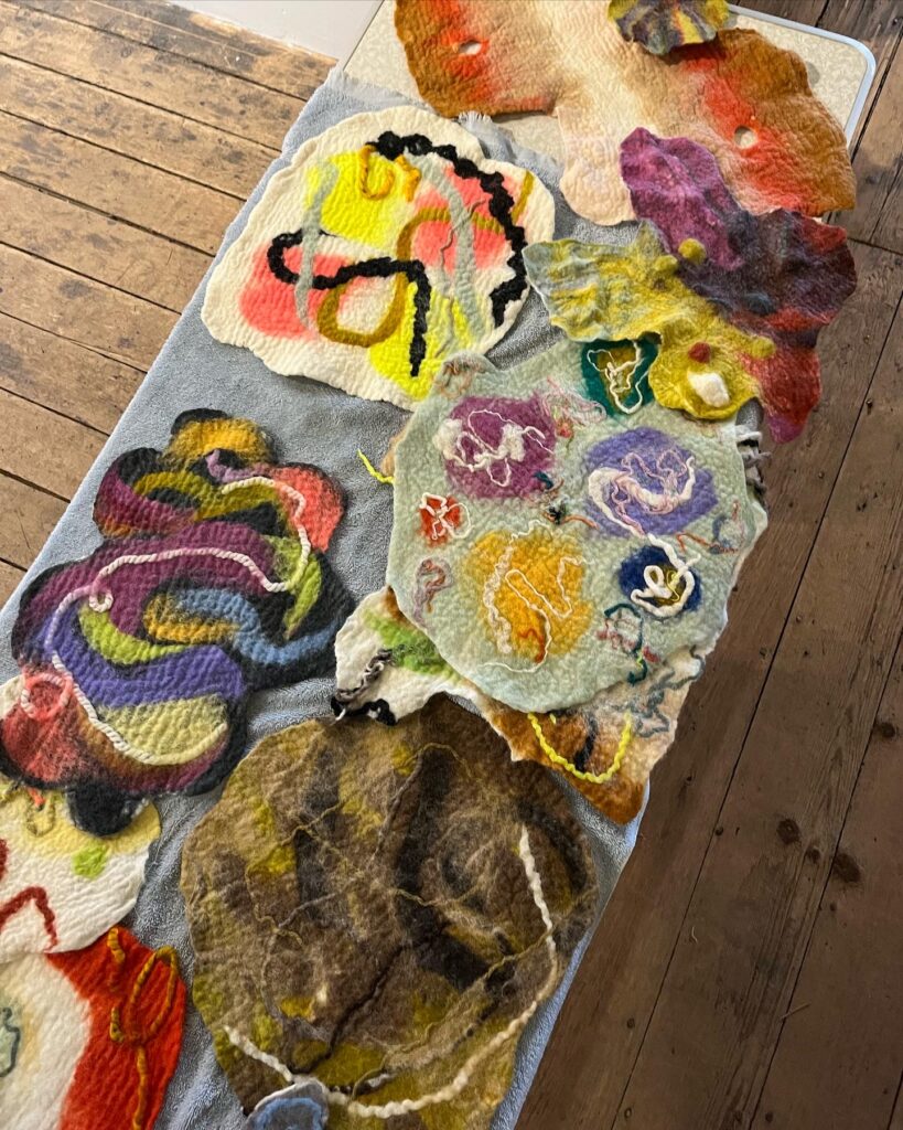 A fabric with patchy designs created in wet felt.