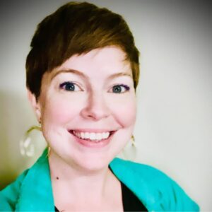 Smiling woman, Evie Digirolamo wearing earrings.