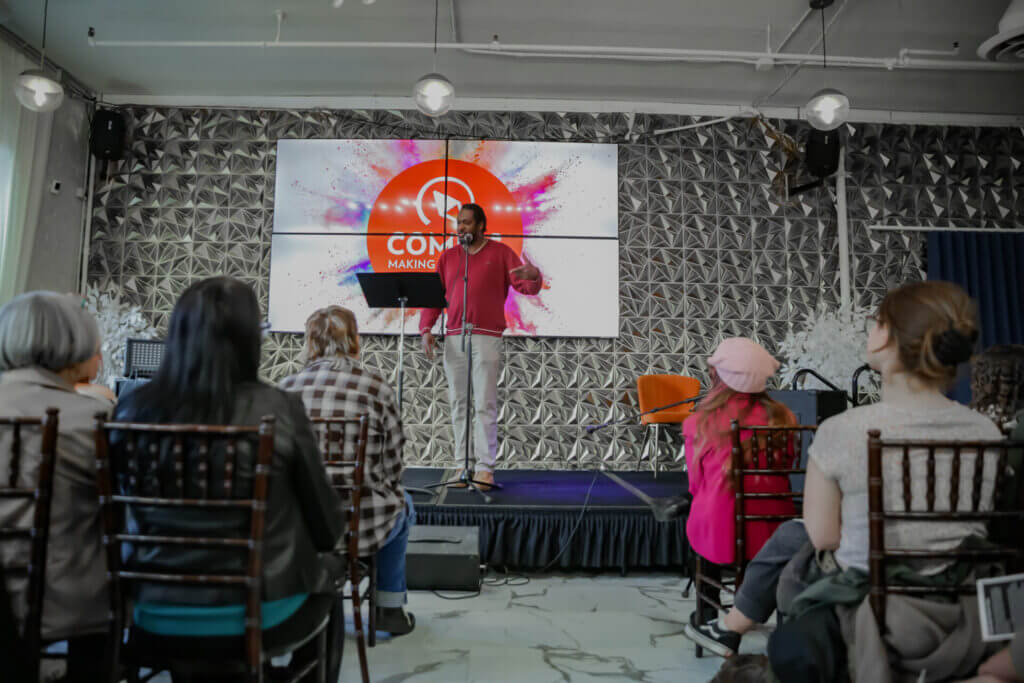Frank Sentwali performing in front of the audience at the 2026 Youth Spoken Word Showcase.