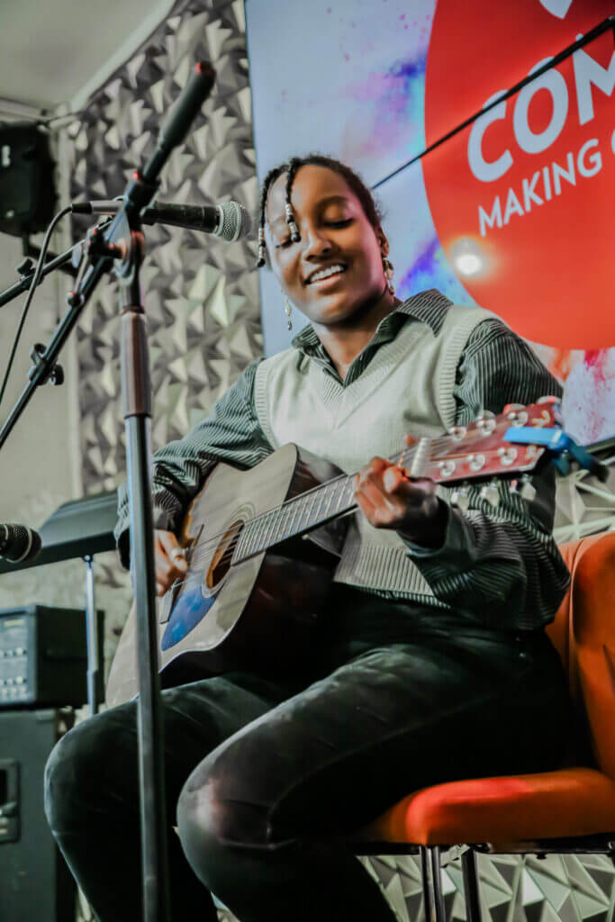 Jada performing music at the 2026 Youth Spoken Word Showcase.