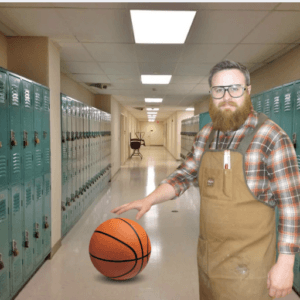 A bearded man wearing glasses, a plaid shirt, and a canvas work apron stands in a school hallway lined with lockers, resting his hand on a basketball.