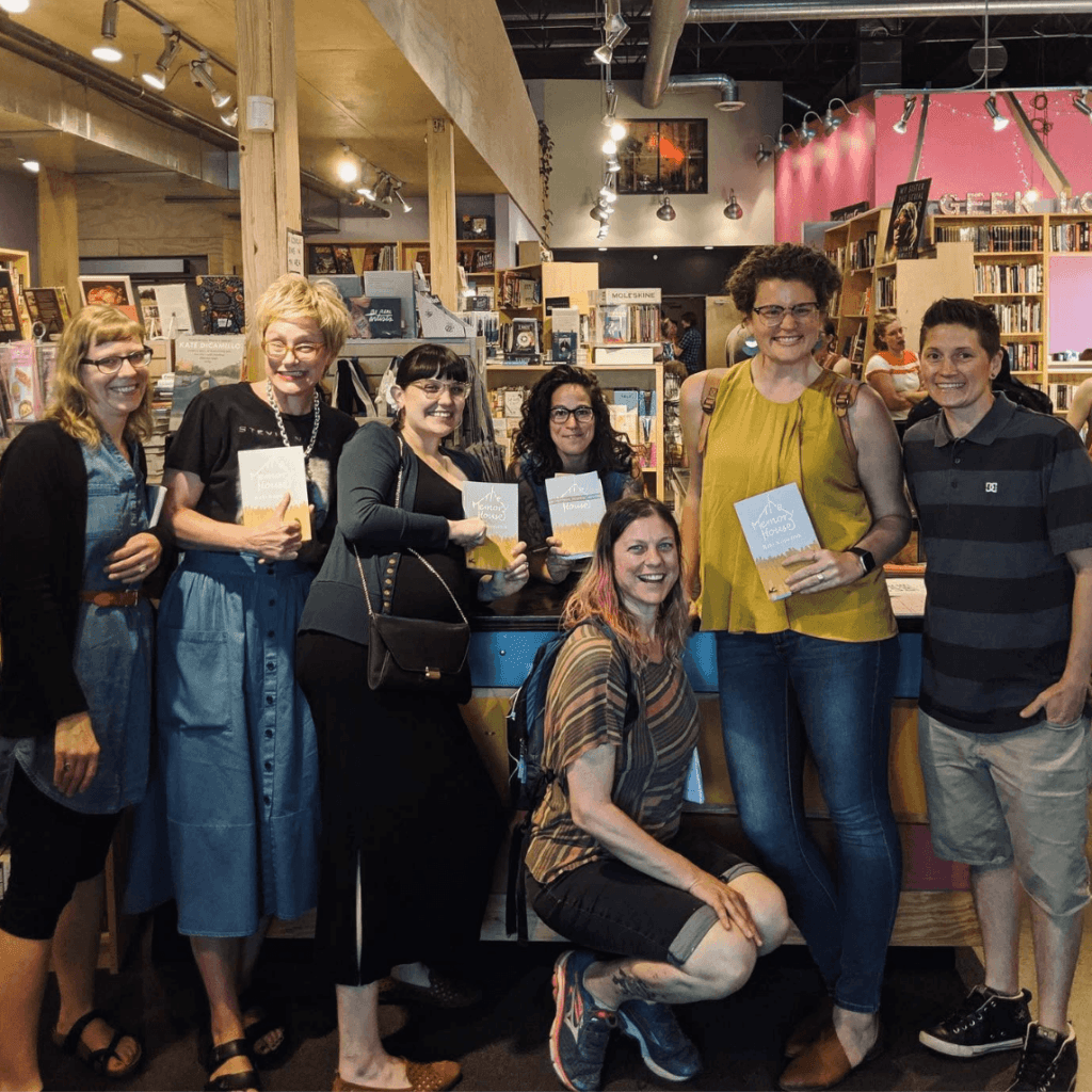 Raki with a group of happy people holding books.