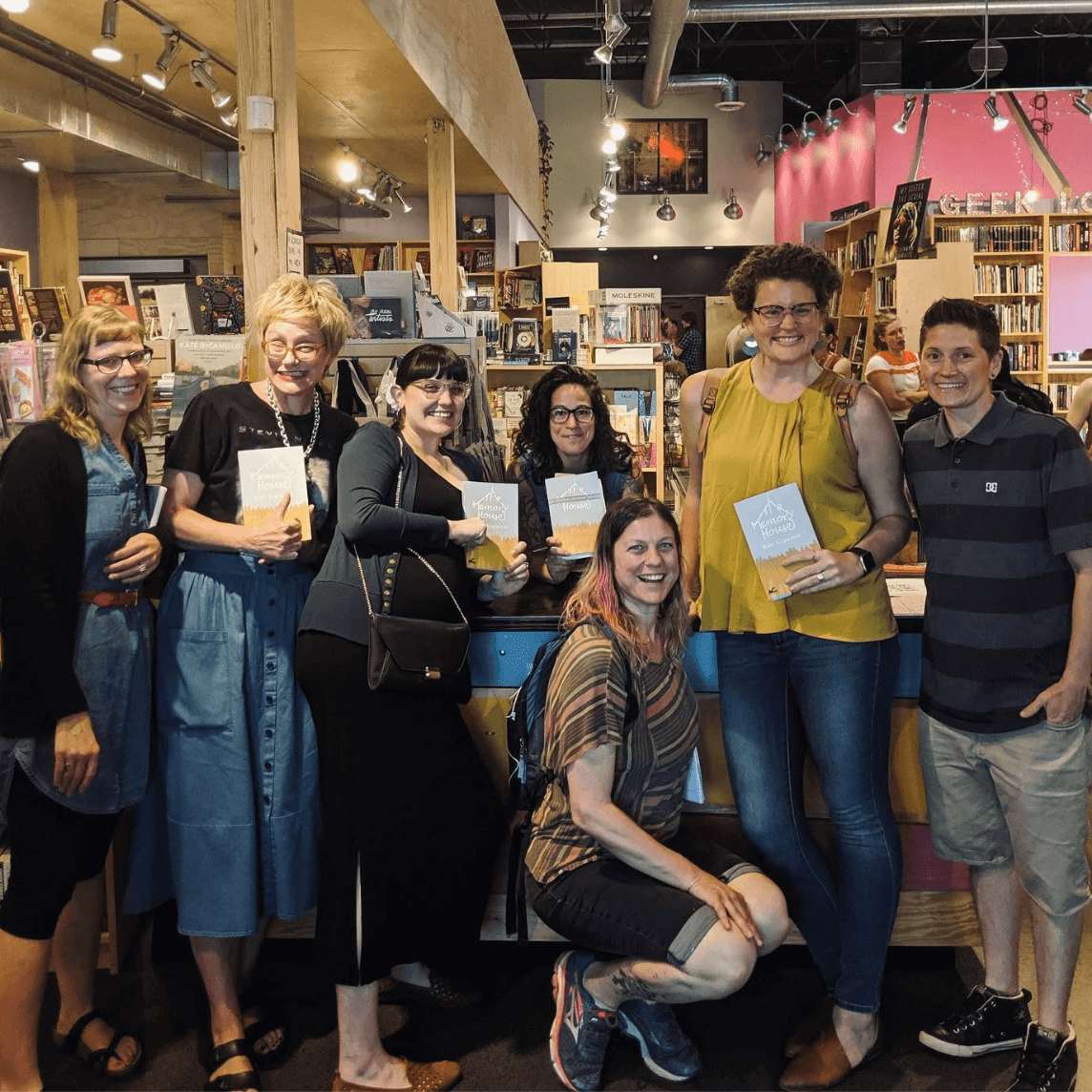 Raki in the middle of a group of smiling authors.